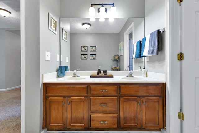 bathroom featuring a textured ceiling and vanity