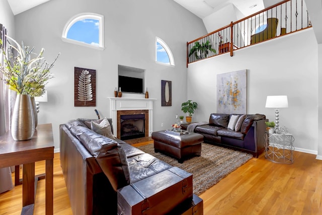 living room with wood-type flooring and high vaulted ceiling