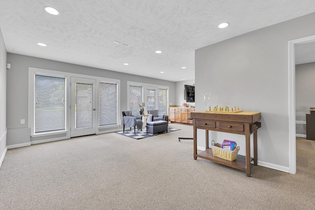 living room featuring carpet floors and a textured ceiling