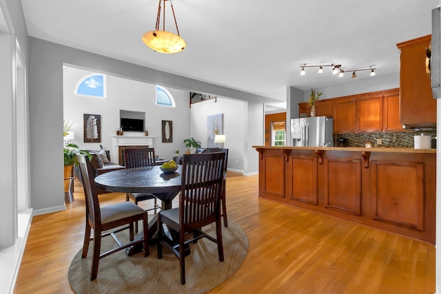 dining space featuring plenty of natural light and light hardwood / wood-style floors