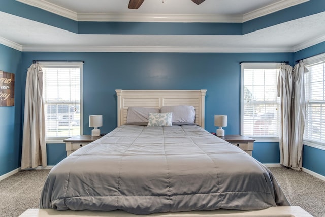 bedroom featuring ornamental molding, a raised ceiling, ceiling fan, and carpet