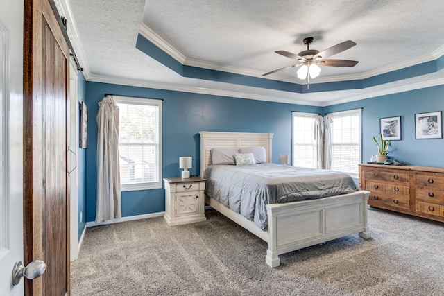 bedroom featuring a tray ceiling, light colored carpet, a barn door, and ceiling fan