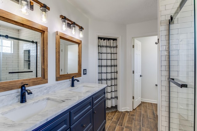 bathroom featuring walk in shower and vanity