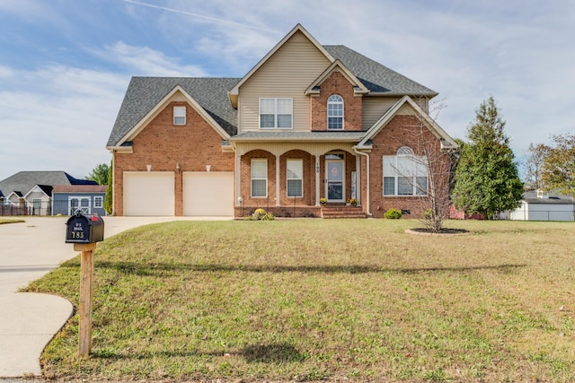 view of front of home with a porch, a garage, and a front yard