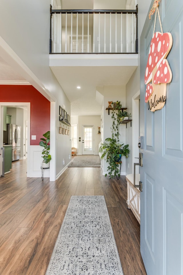 foyer with crown molding and dark hardwood / wood-style floors