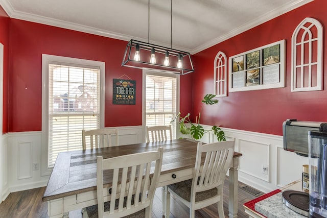 dining area with crown molding and dark hardwood / wood-style flooring