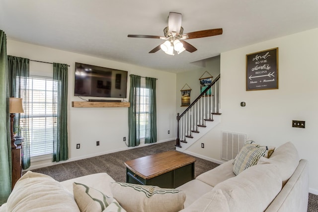 carpeted living room featuring ceiling fan