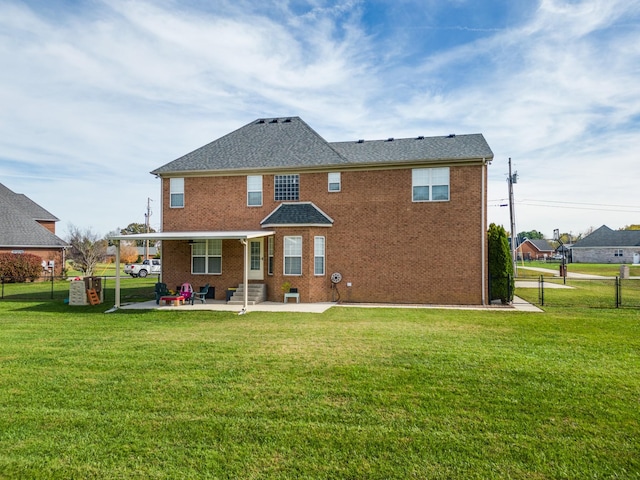 rear view of house featuring a yard and a patio area