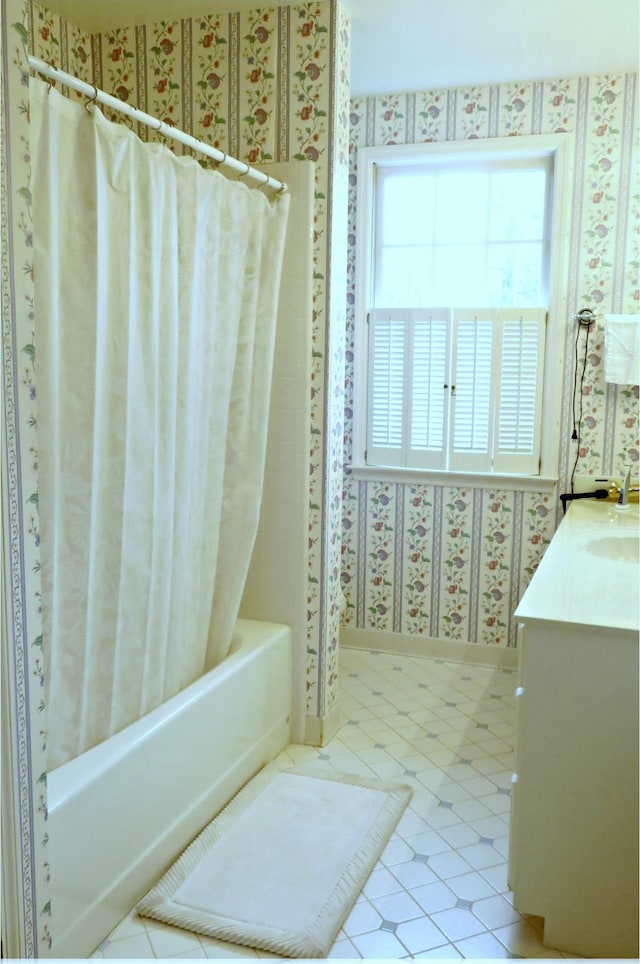 bathroom featuring shower / bath combo with shower curtain and vanity