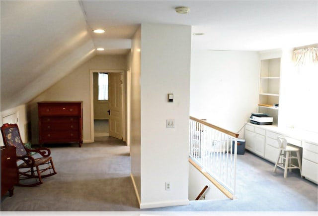 home office featuring light carpet and vaulted ceiling