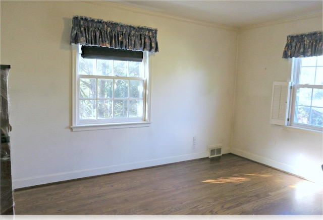 empty room with dark hardwood / wood-style floors and ornamental molding