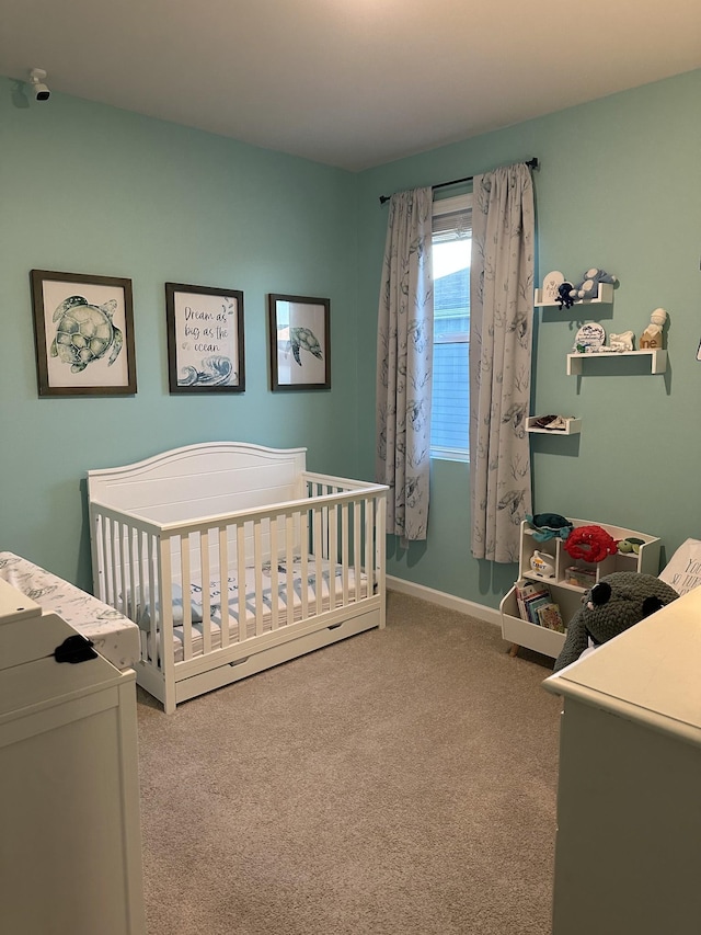 carpeted bedroom featuring a crib