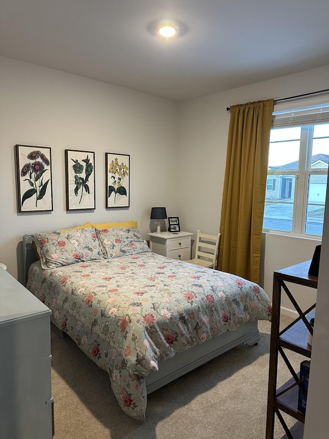 bedroom featuring light colored carpet