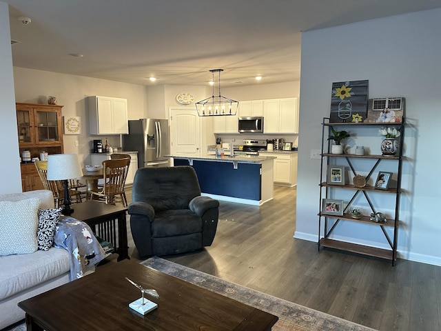 living room featuring dark hardwood / wood-style flooring and a chandelier