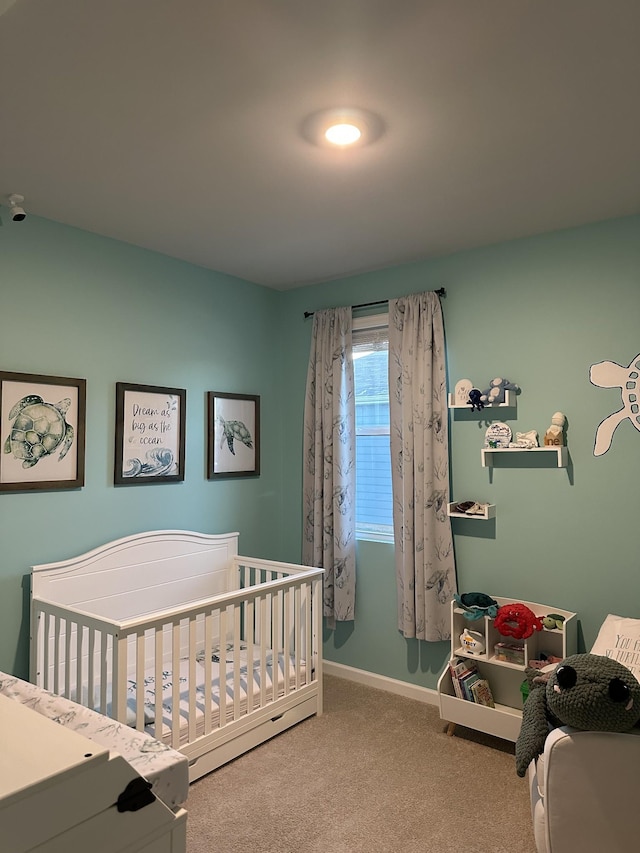 carpeted bedroom with a nursery area