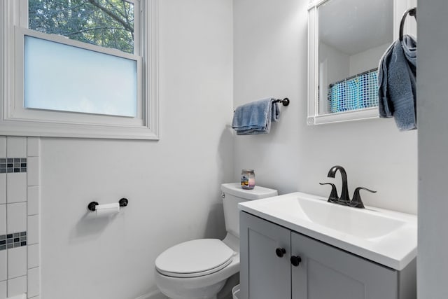 bathroom featuring vanity, toilet, and curtained shower