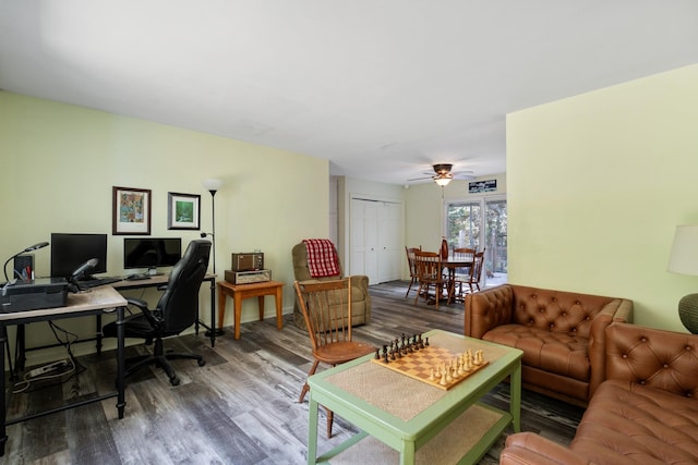 living room featuring ceiling fan and hardwood / wood-style floors