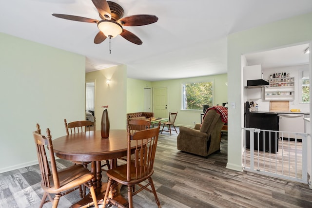 dining space featuring ceiling fan and hardwood / wood-style flooring