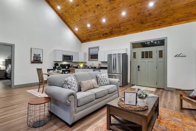 living room featuring high vaulted ceiling, wooden ceiling, and wood-type flooring