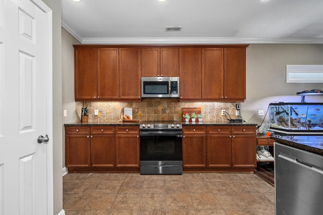 kitchen featuring decorative backsplash, appliances with stainless steel finishes, crown molding, and dark stone counters