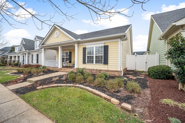 view of front of home with covered porch and a front yard