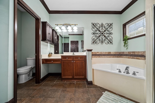 bathroom with a tub, toilet, vanity, and ornamental molding