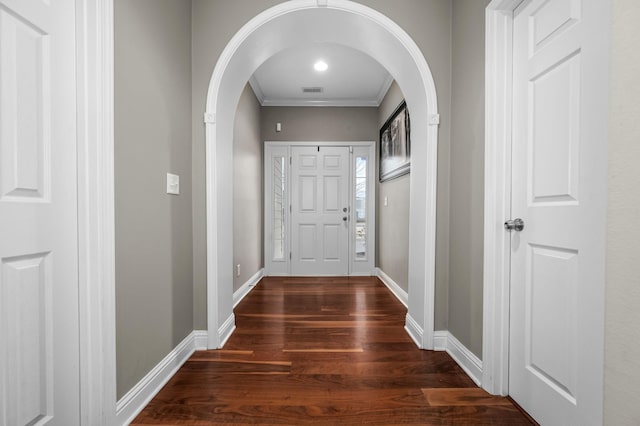 entryway with crown molding and dark hardwood / wood-style floors