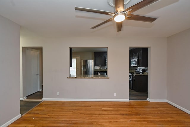 unfurnished living room with hardwood / wood-style flooring and ceiling fan