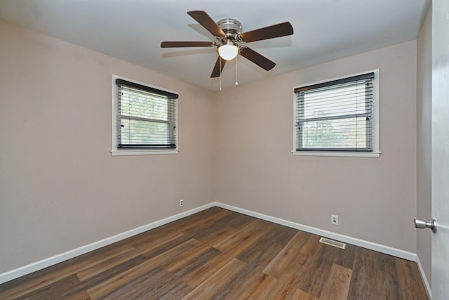 spare room featuring dark hardwood / wood-style floors and ceiling fan