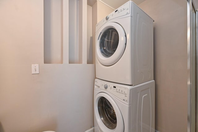 laundry area with stacked washing maching and dryer