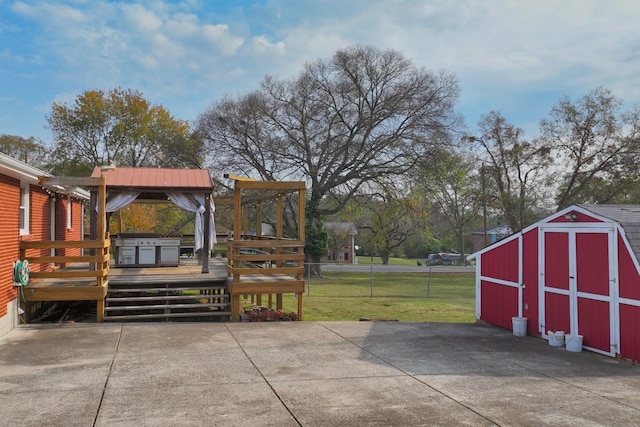 view of patio / terrace featuring a storage unit and a deck