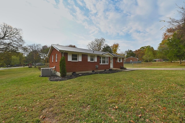 single story home with cooling unit and a front lawn