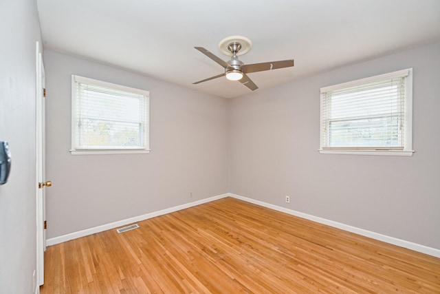 empty room with ceiling fan and light wood-type flooring