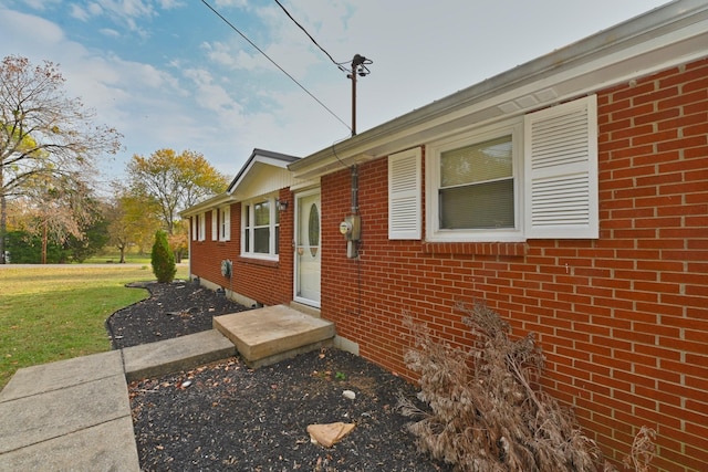 view of side of home featuring a yard