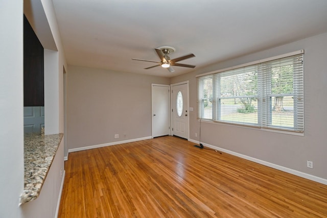 entryway with ceiling fan and light hardwood / wood-style flooring