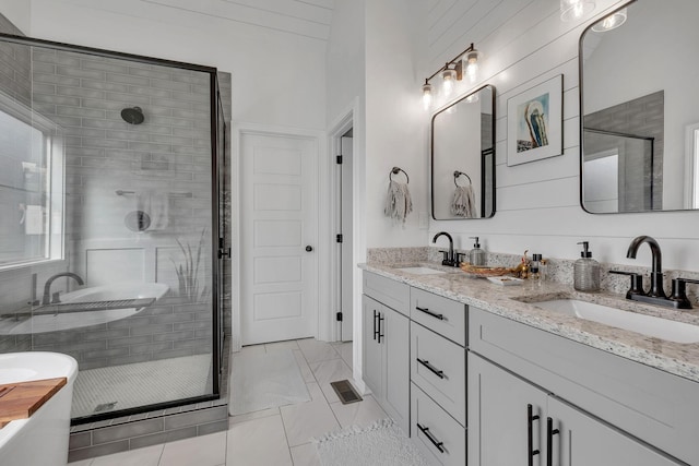 bathroom with tile patterned flooring, vanity, and independent shower and bath