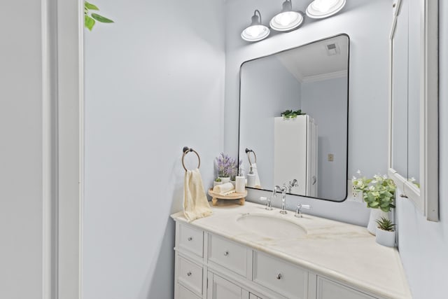 bathroom with vanity and crown molding