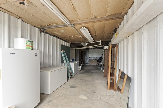 basement with white refrigerator, washer / clothes dryer, and fridge