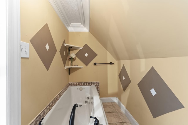 bathroom with tile patterned flooring, ornamental molding, a bath, and a textured ceiling