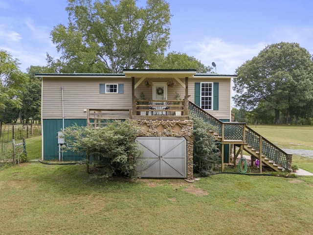 rear view of house with a lawn and a garage