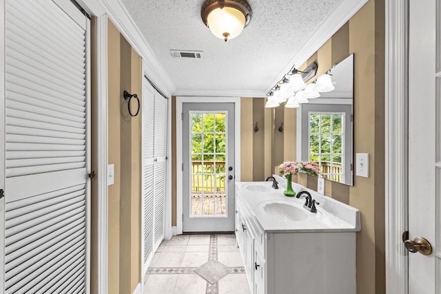 bathroom featuring crown molding, vanity, and a textured ceiling