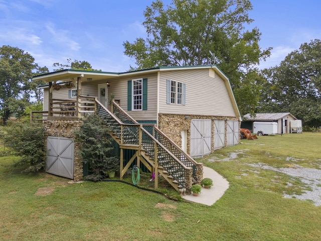 rear view of house with a deck and a yard