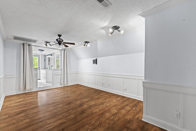 unfurnished room with a textured ceiling, ceiling fan, dark hardwood / wood-style floors, and vaulted ceiling