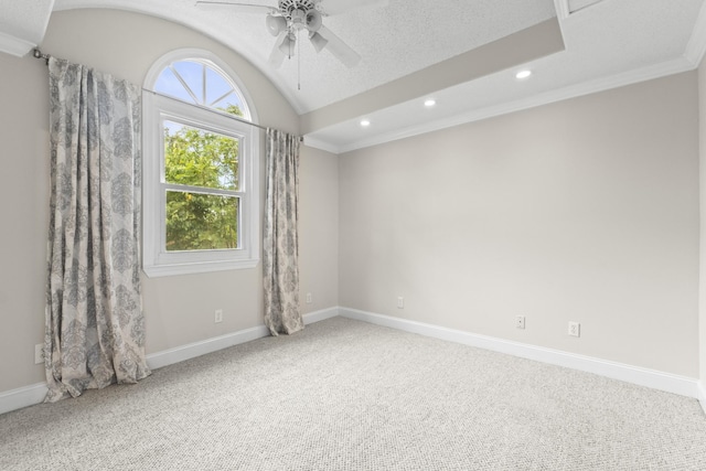 spare room featuring carpet floors, vaulted ceiling, ceiling fan, and crown molding