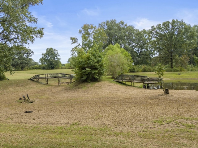 view of community featuring a yard and a water view