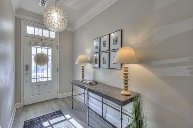 foyer entrance featuring hardwood / wood-style floors and ornamental molding