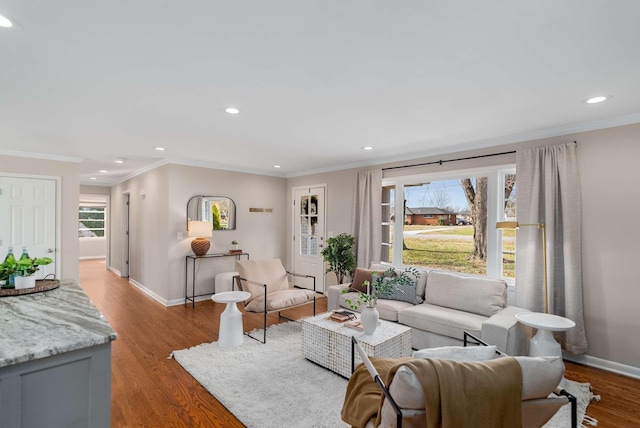 living room with light wood-type flooring and crown molding