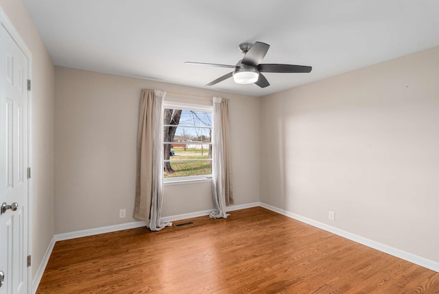 spare room featuring ceiling fan and hardwood / wood-style floors