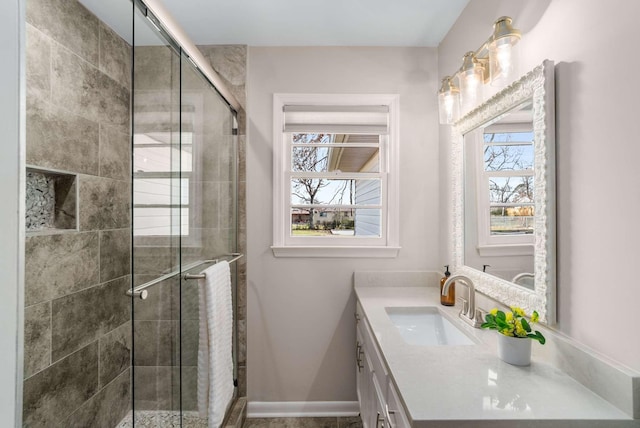 bathroom with a shower with door and vanity