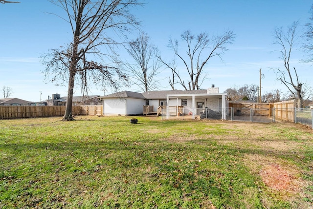 rear view of house featuring a wooden deck and a lawn